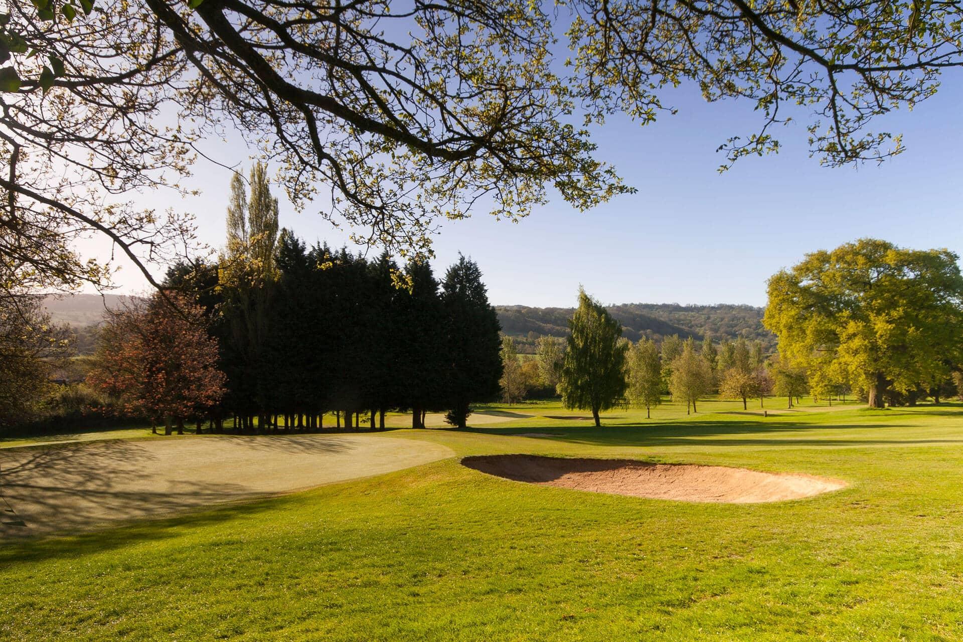 A fairway nestled with a sand bunker