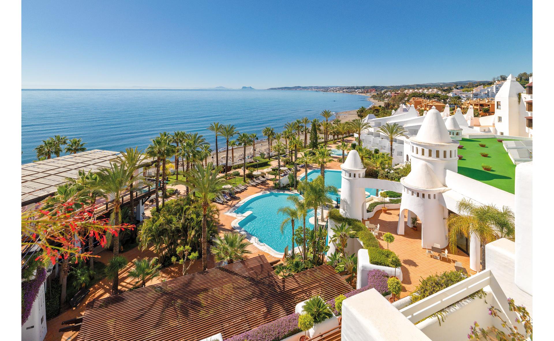 Overhead view of the outdoor swimming pool and coast at H10 Estepona Palace