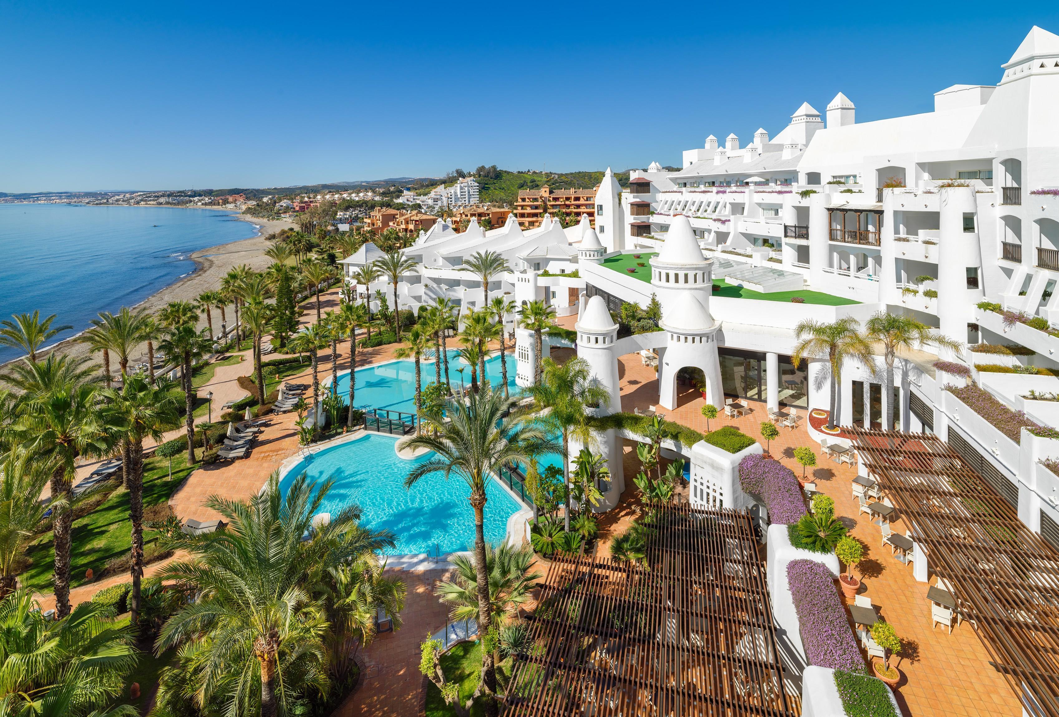 Overhead view of the outdoor swimming pool and coast at H10 Estepona Palace