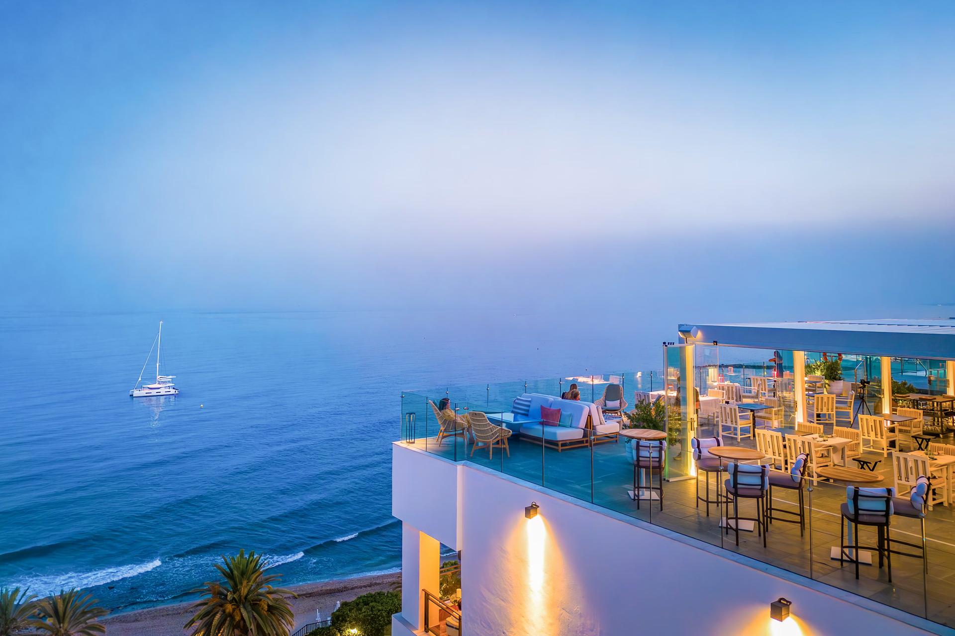 Overhead view of the rooftop dining area at Hotel El Fuerte Marbella with ocean views