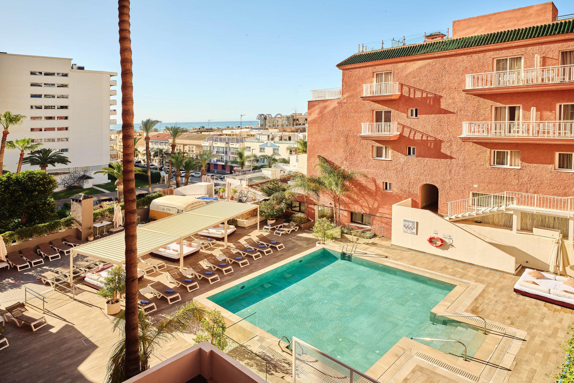 Overhead view of the outdoor swimming pool at Hotel Fenix Torremolinos - Adults Only