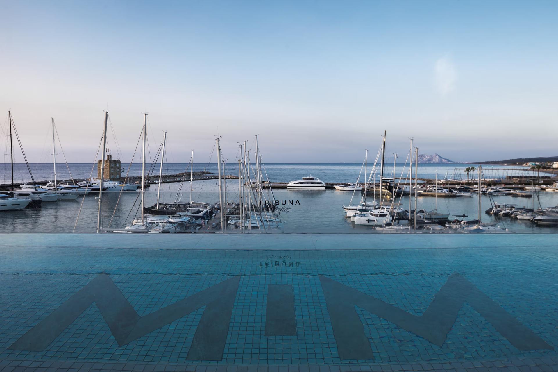 Outdoor swimming pool with dockyard views at Hotel MiM Sotogrande Melia