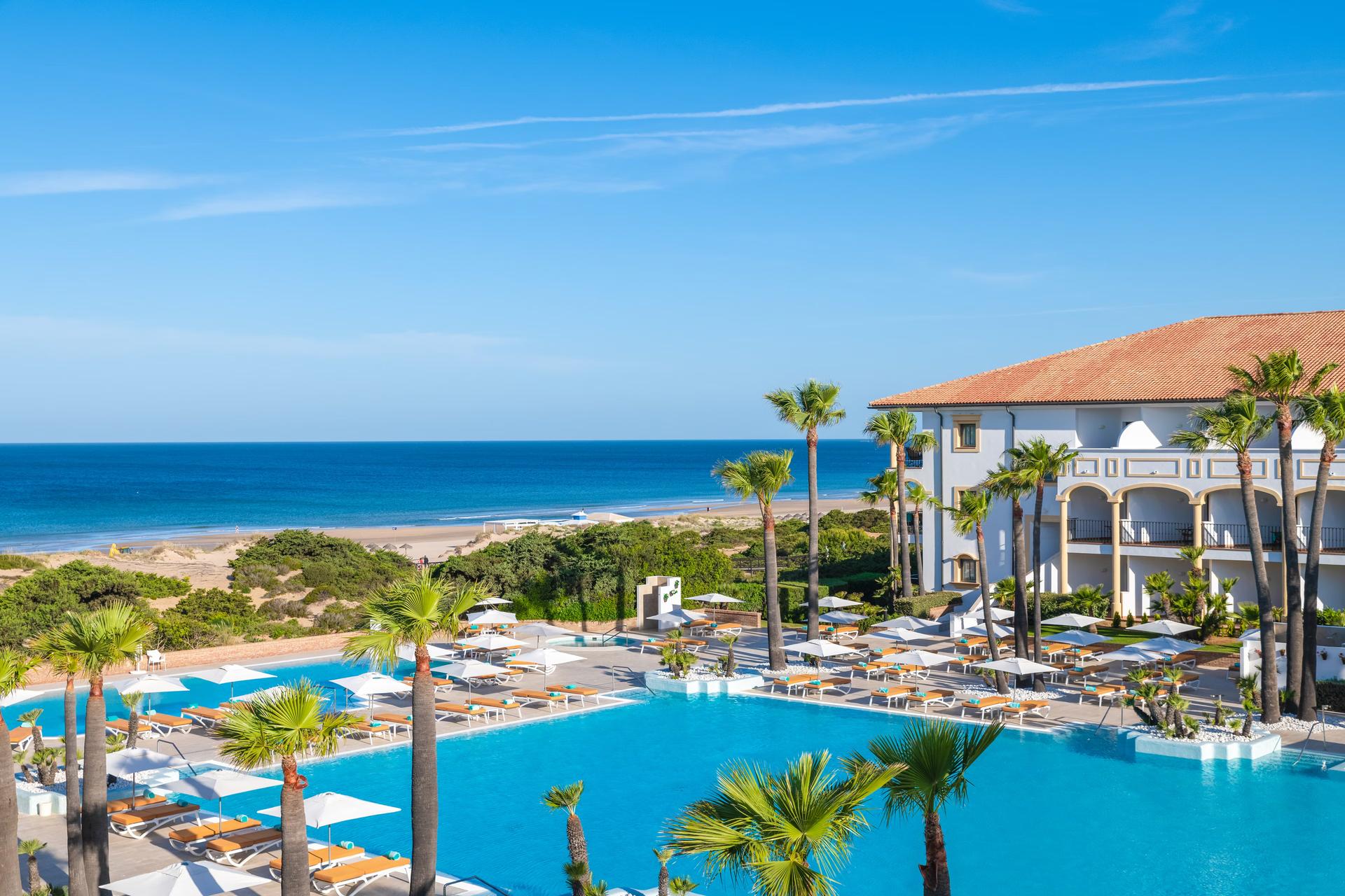 Overhead view of the Iberostar Selection Andalucia Playa overlooking the outdoor swimming pool at Iberostar Selection Andalucia Playa