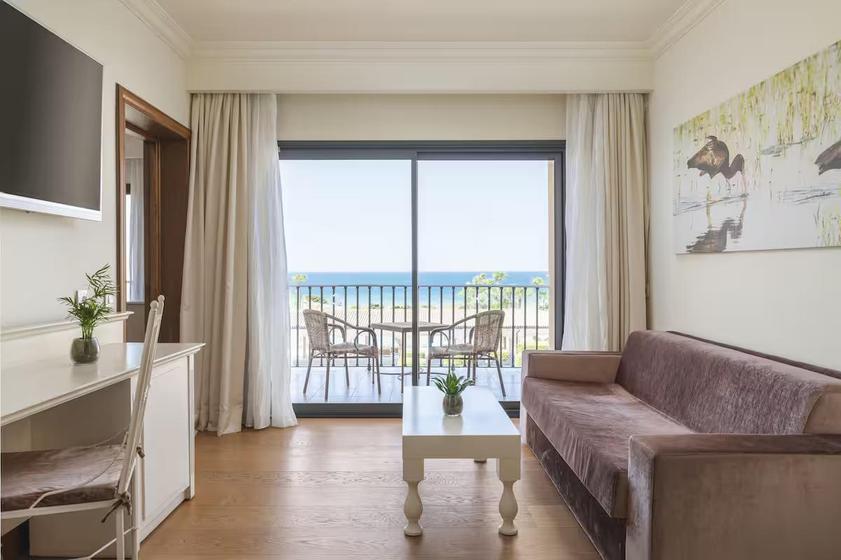 Living room as part of a suite at Iberostar Selection Andalucia Playa with balcony beach views