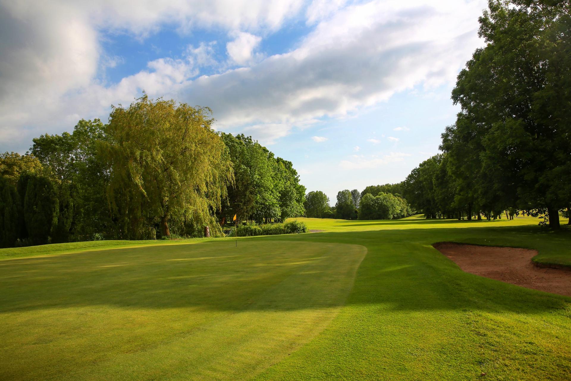 A well maintained fairway leading to a smooth green