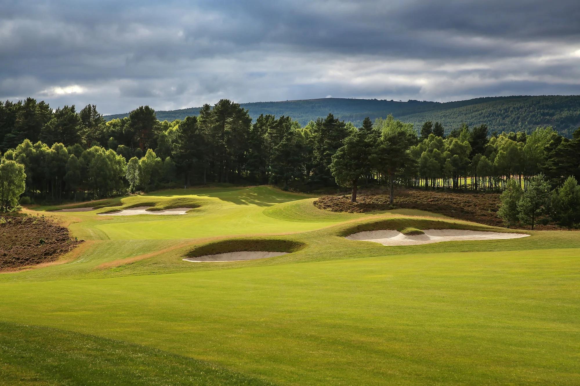 A winding fairway littered with sand bunkers