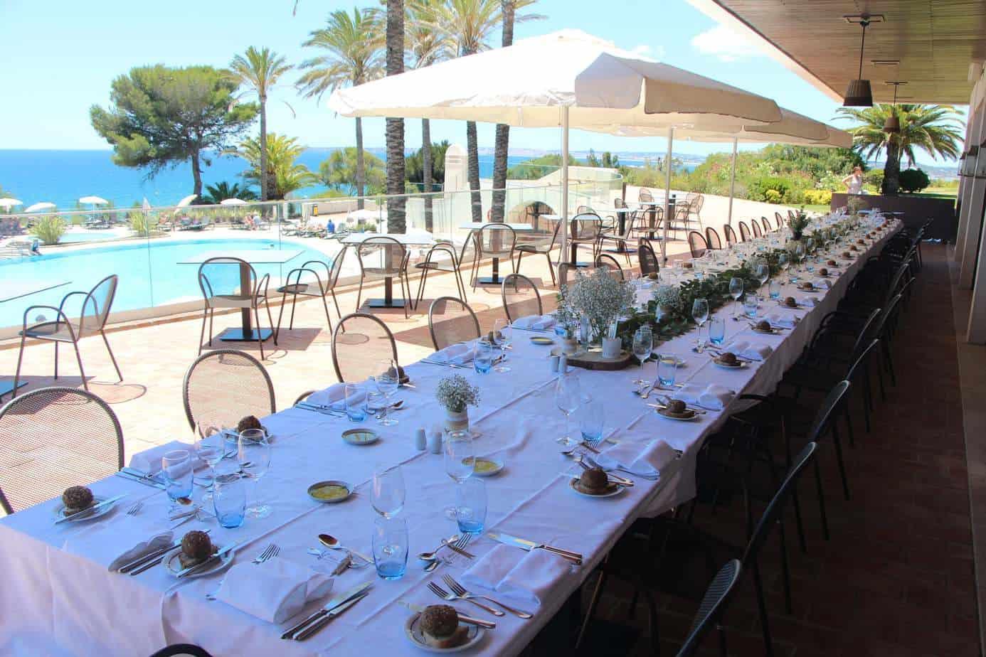 Outdoor poolside dining area at the Pestana Alvor Praia Premium Beach & Golf Resort