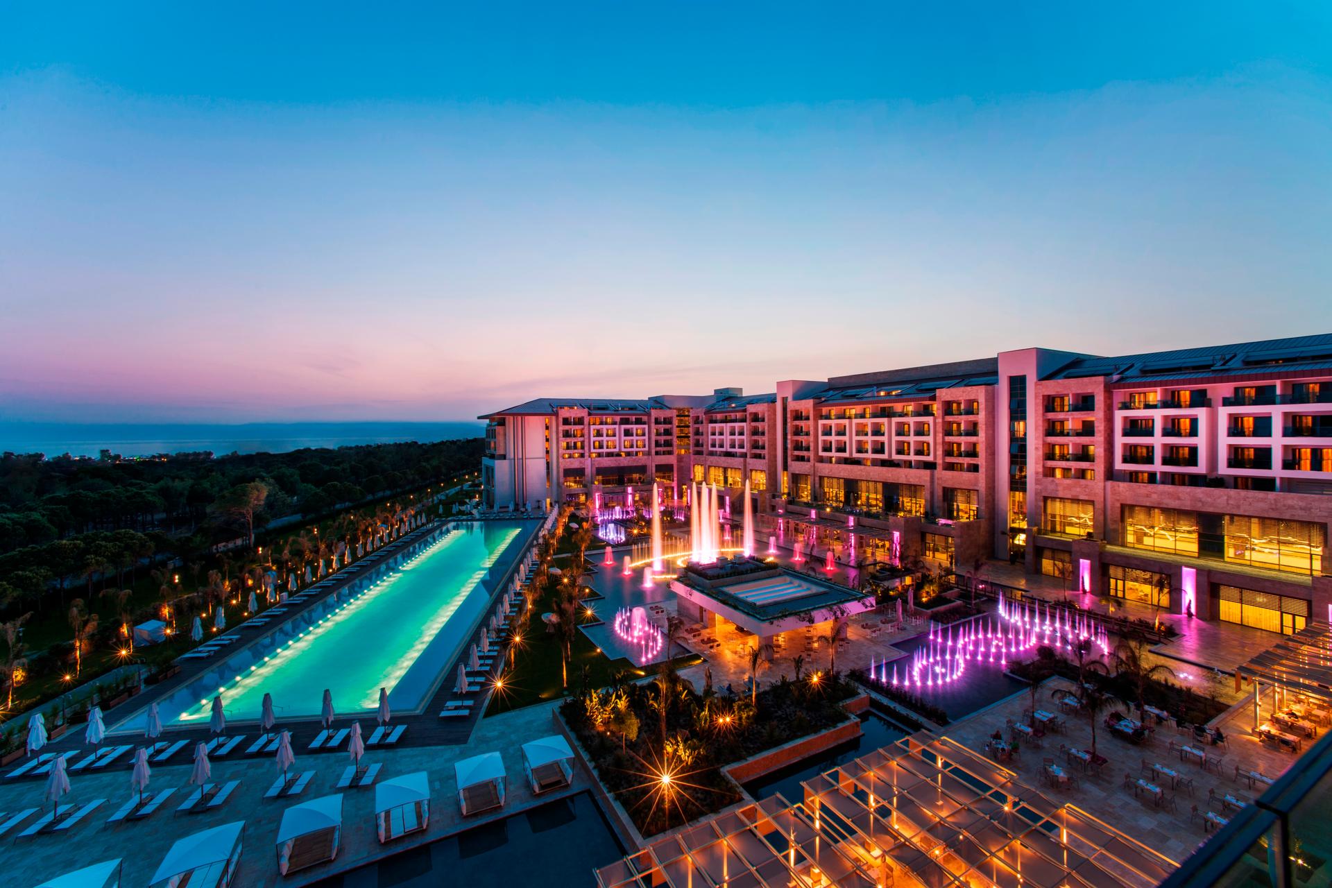 Panoramic view of the Regnum Carya Golf & Spa Resort lit up at night