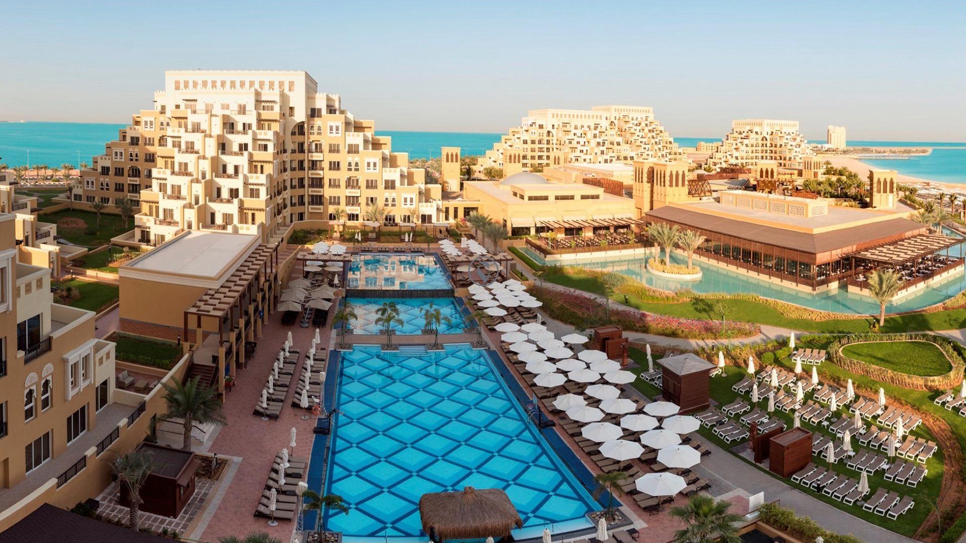 Overhead view of the Rixos Premium Saadiyat Island outdoor pool and building