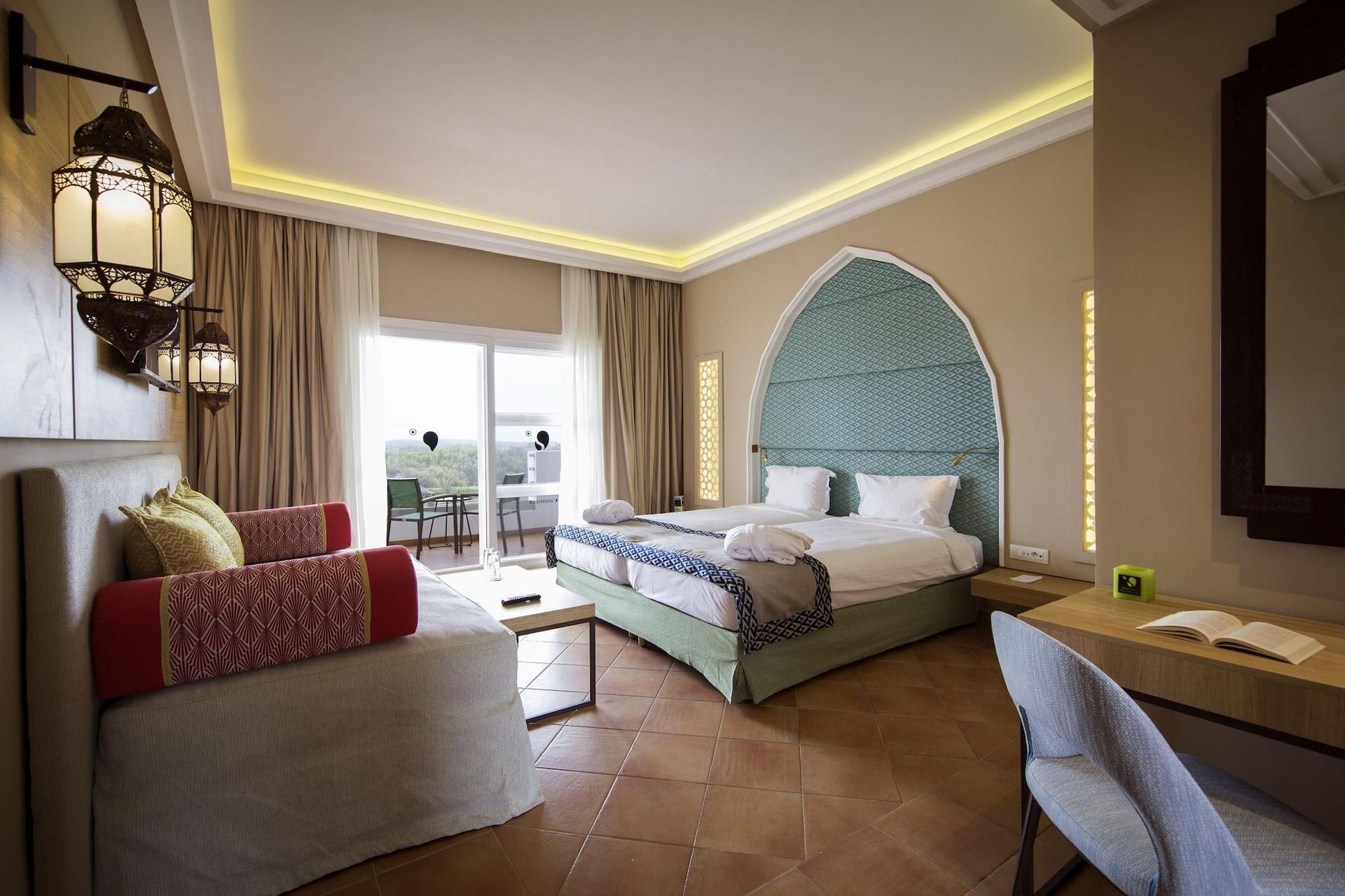 A spacious double bed room at Robinson Agadir with balcony views