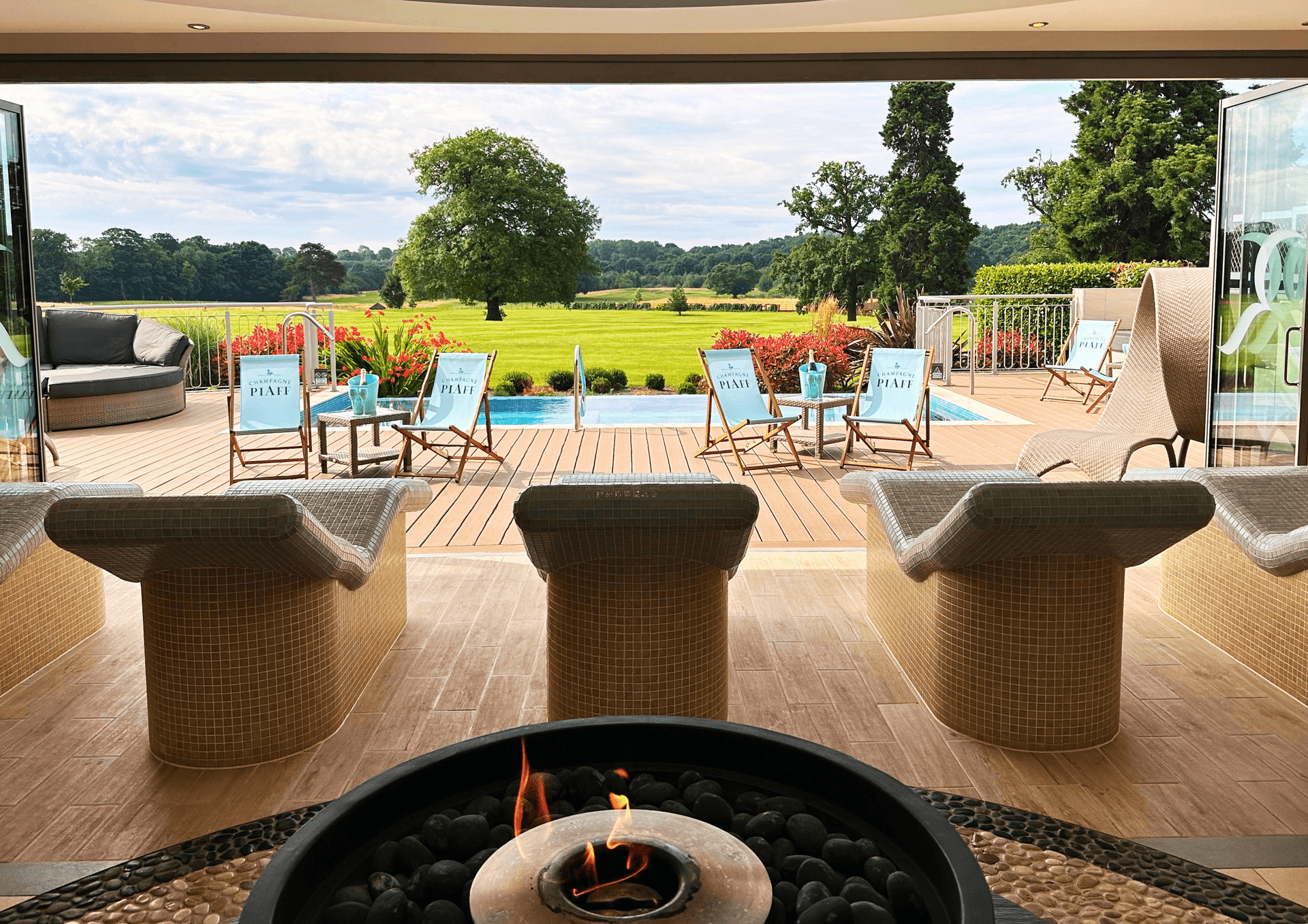 Sunbeds next to the outdoor swimming pool at Rockliffe Hall Hotel Golf & Spa 5*