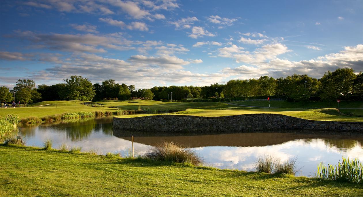 A well maintained fairway running besides a water hazard at Rudding Park Hotel & Golf Club