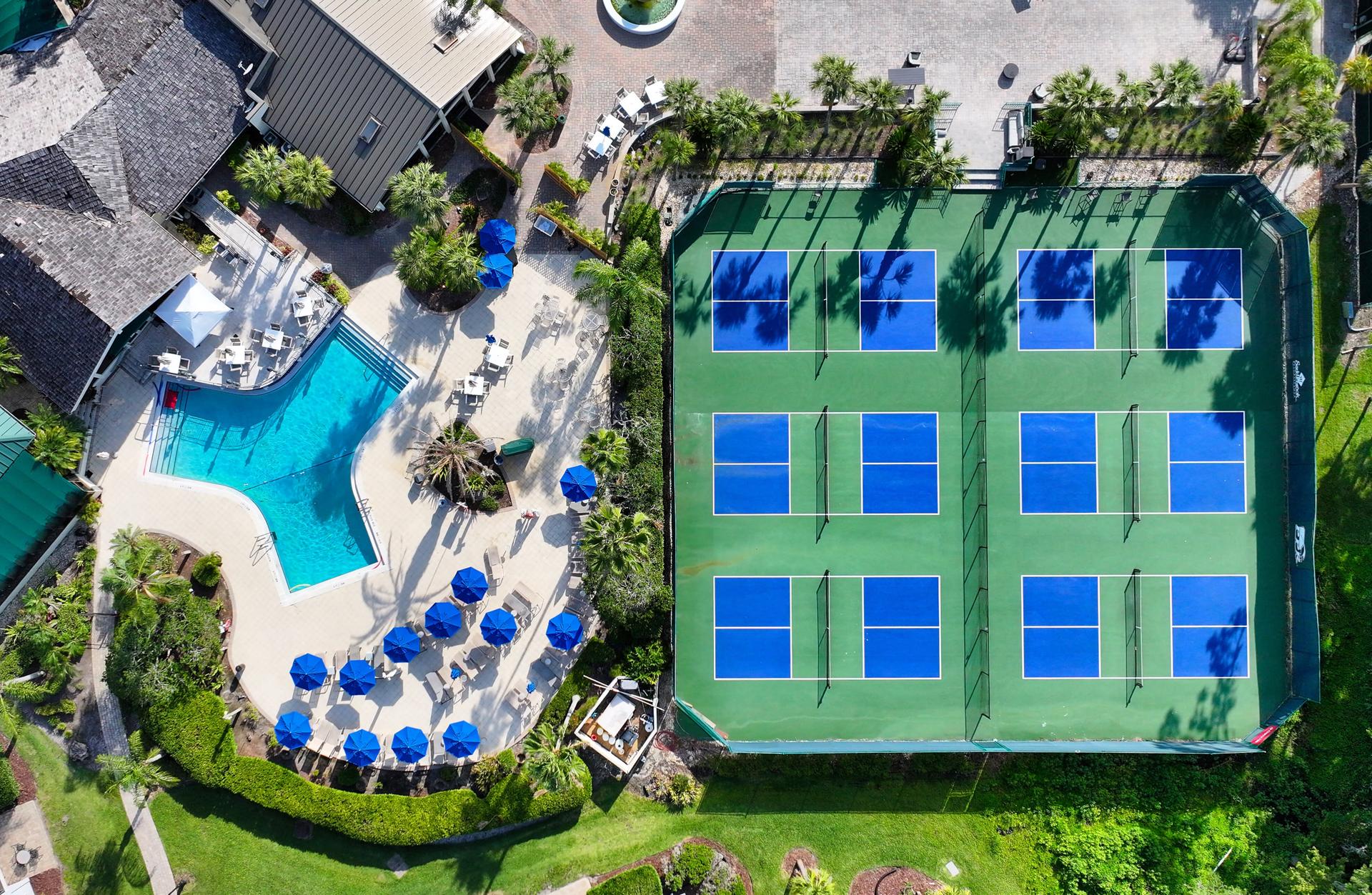 Birdseye view of a tennis court next to a villa at Saddlebrook Resort