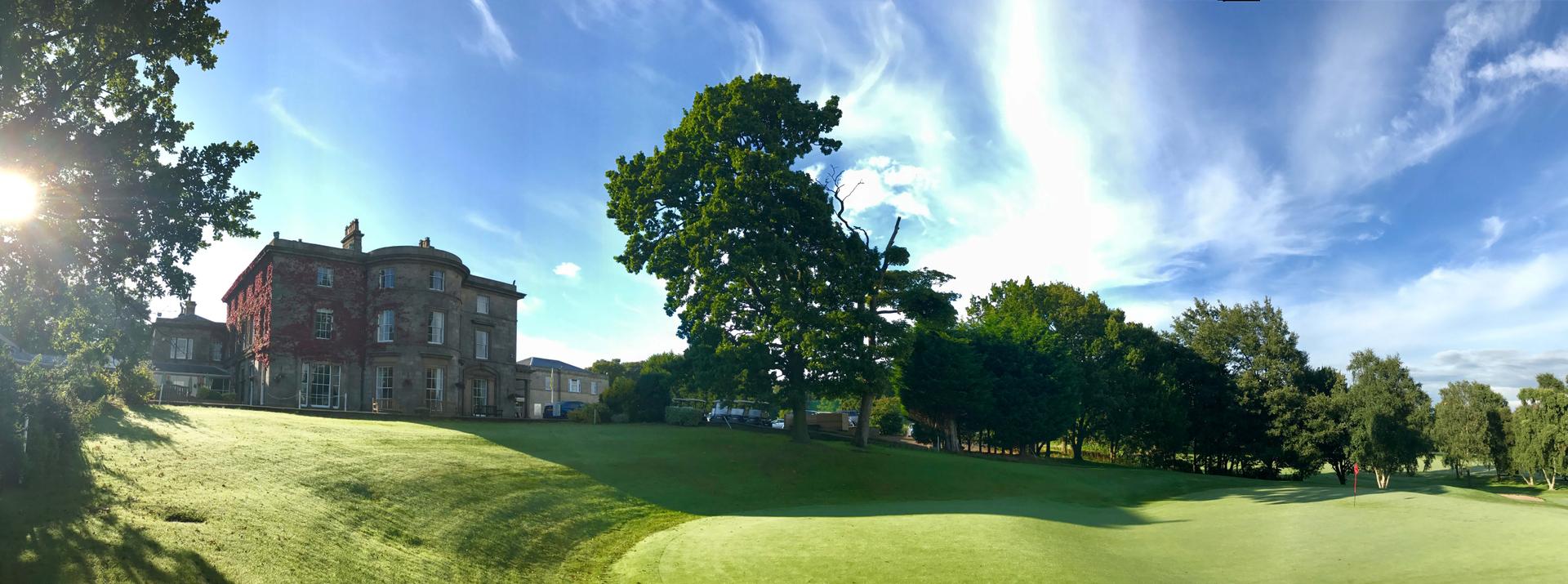 Panoramic view of the Shaw Hill Golf Resort & Spa Hotel building overlooking the course