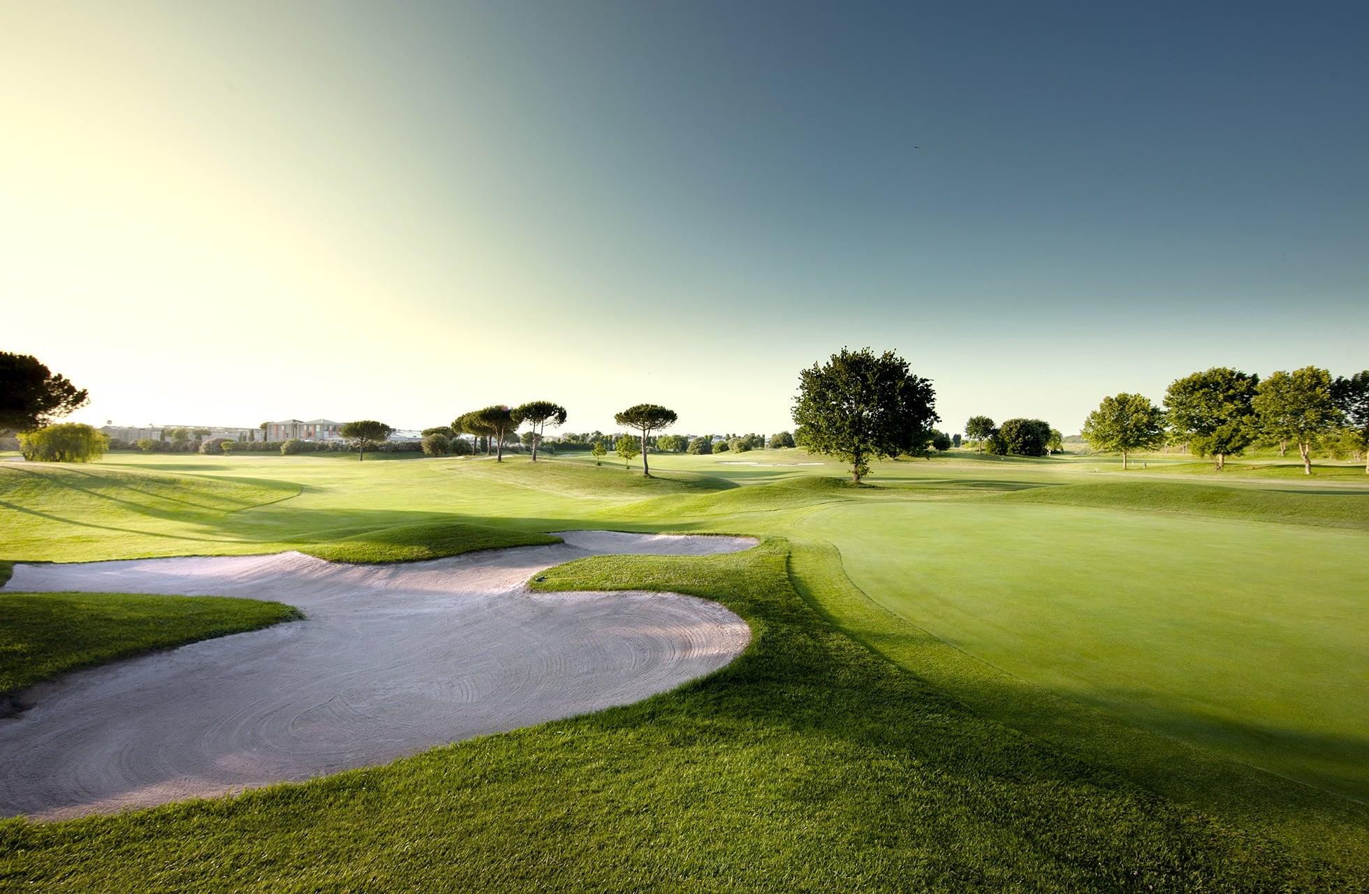 A well maintained fairway nestled with sand bunkers