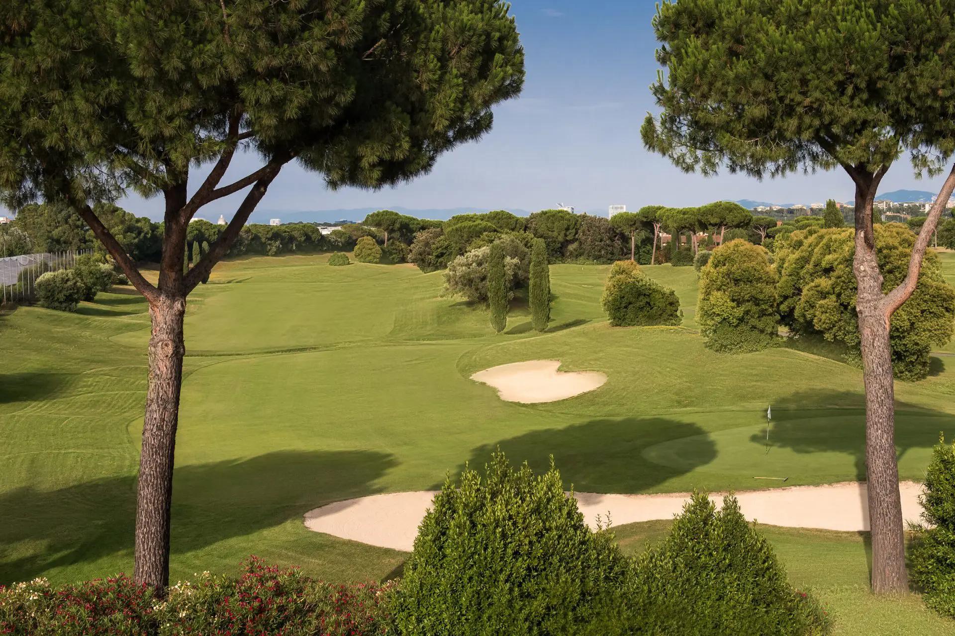 A well maintained fairway nestled with sand bunkers