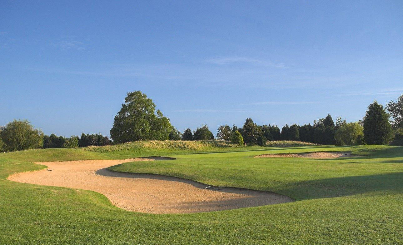 A winding fairway nestled with sand bunkers