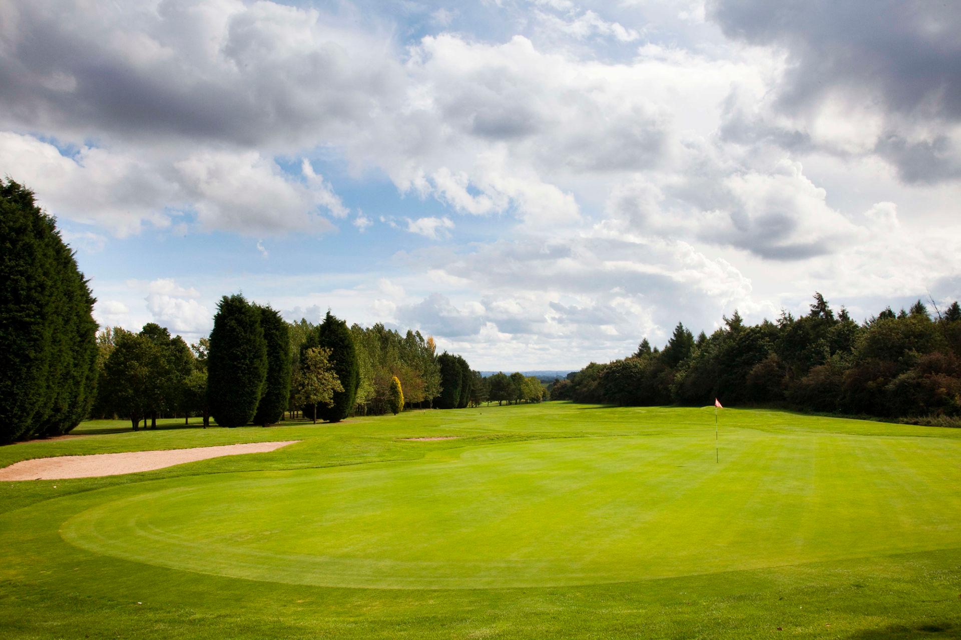 A well maintained fairway leading to a smooth green