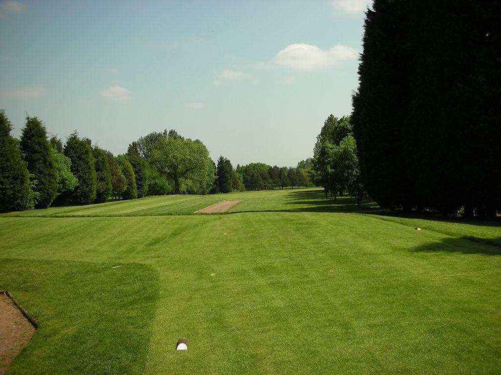 A well maintained fairway leading to a smooth green