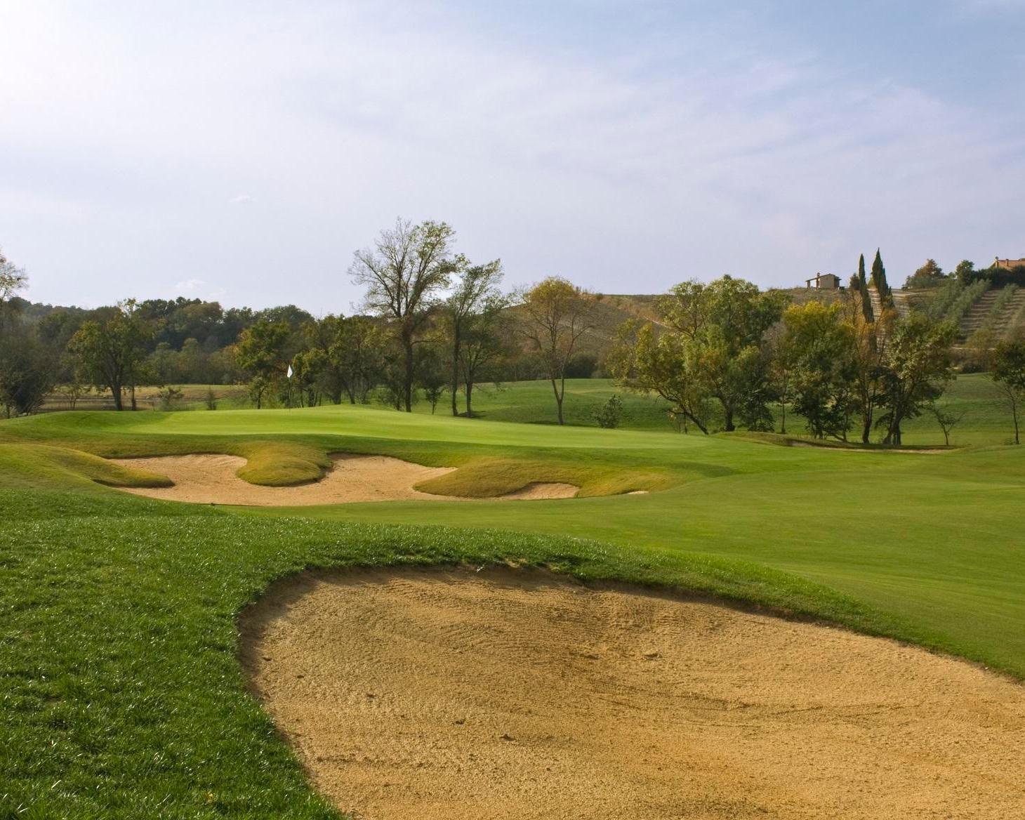 A well maintained fairway nestled with sand bunkers