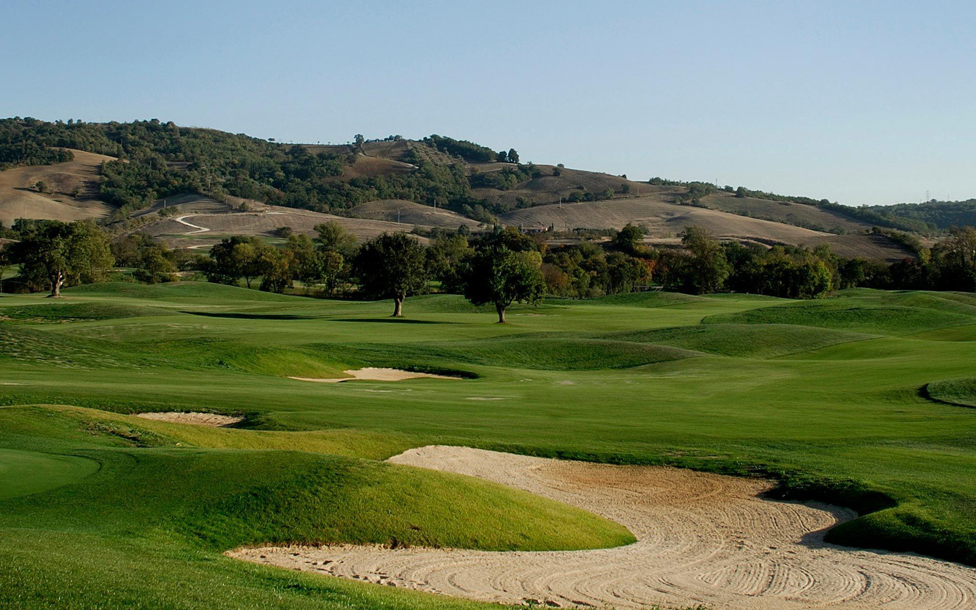 A well maintained fairway nestled with sand bunkers