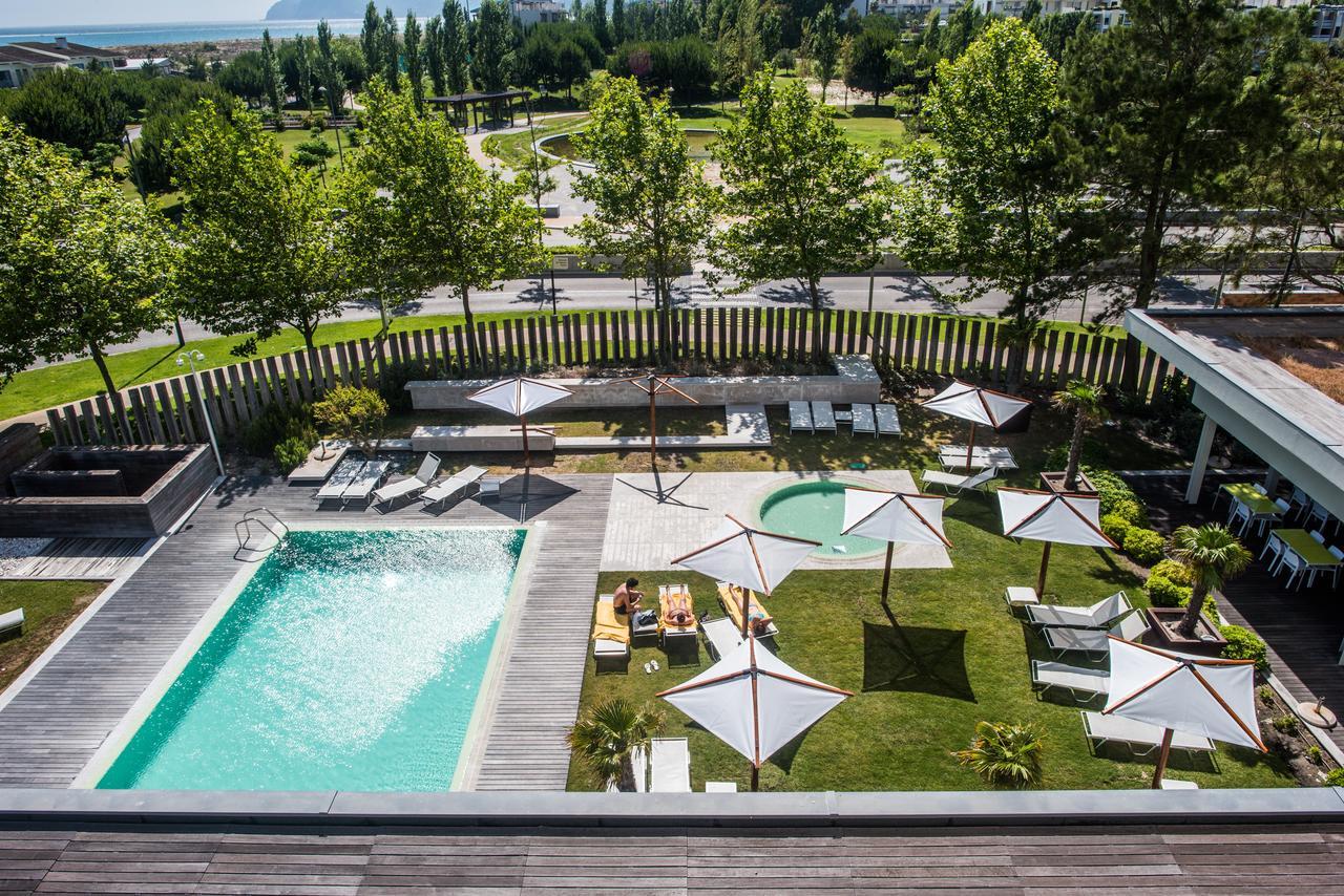 Overhead view of the outdoor swimming pool at The Editory by the Sea Troia Comporta Hotel