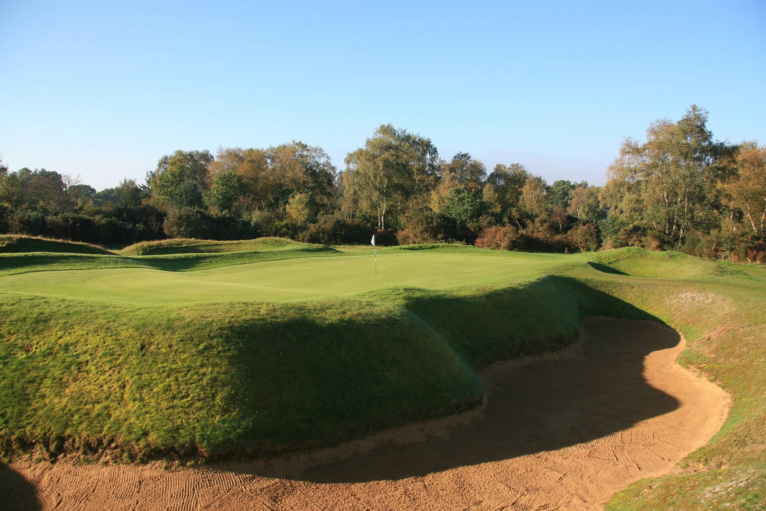 An elevated green surrounded by a sand bunker