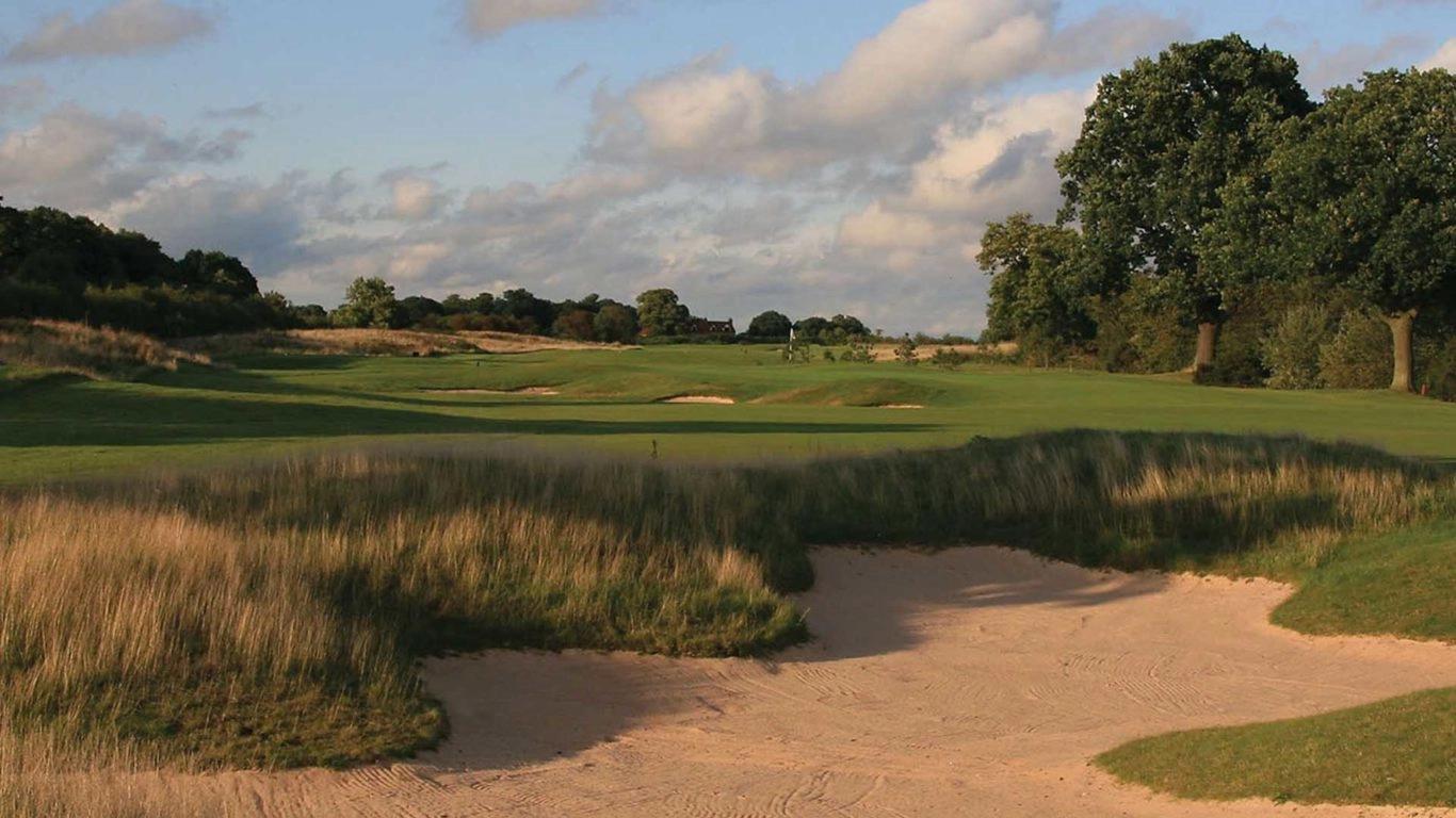 A well maintained fairway with a sand bunker