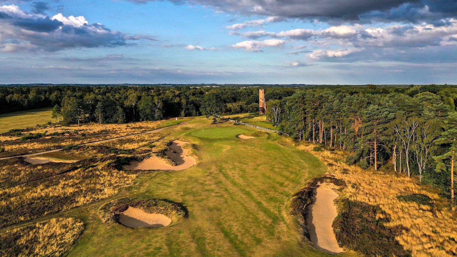 A well maintained fairway nestled with sand bunkers
