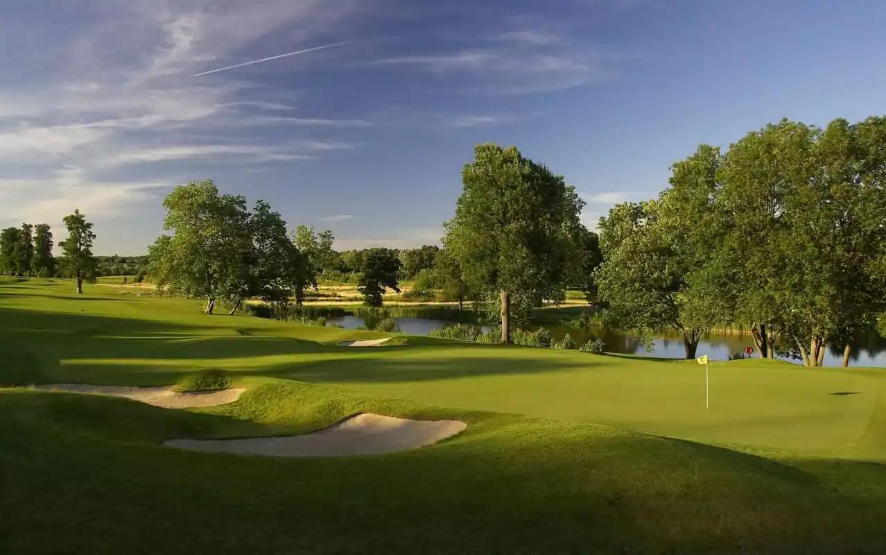 A well maintained fairway nestled with sand bunkers at The Grove, London's Country Estate