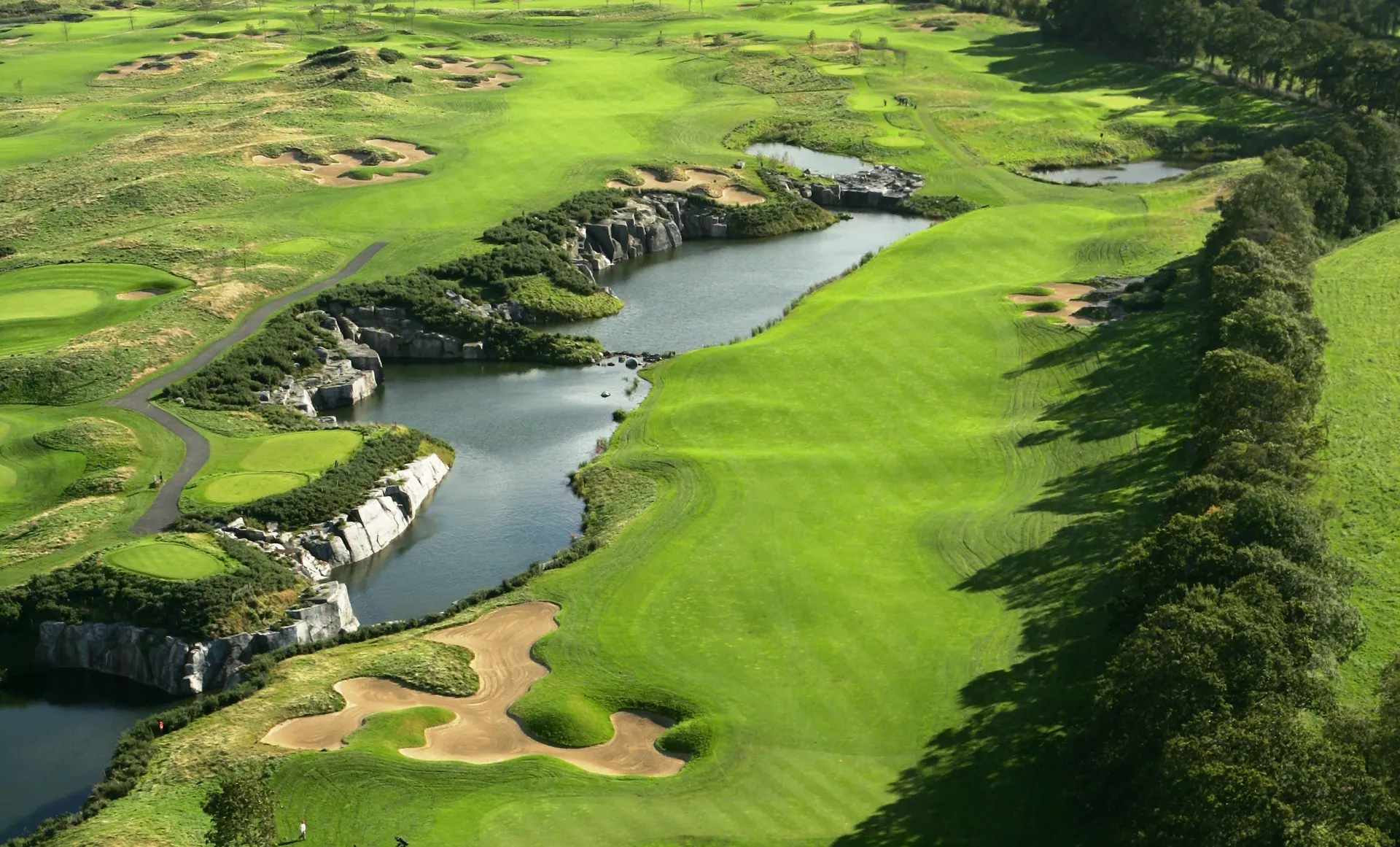 Overhead view of a well maintained fairway next to a water hazard