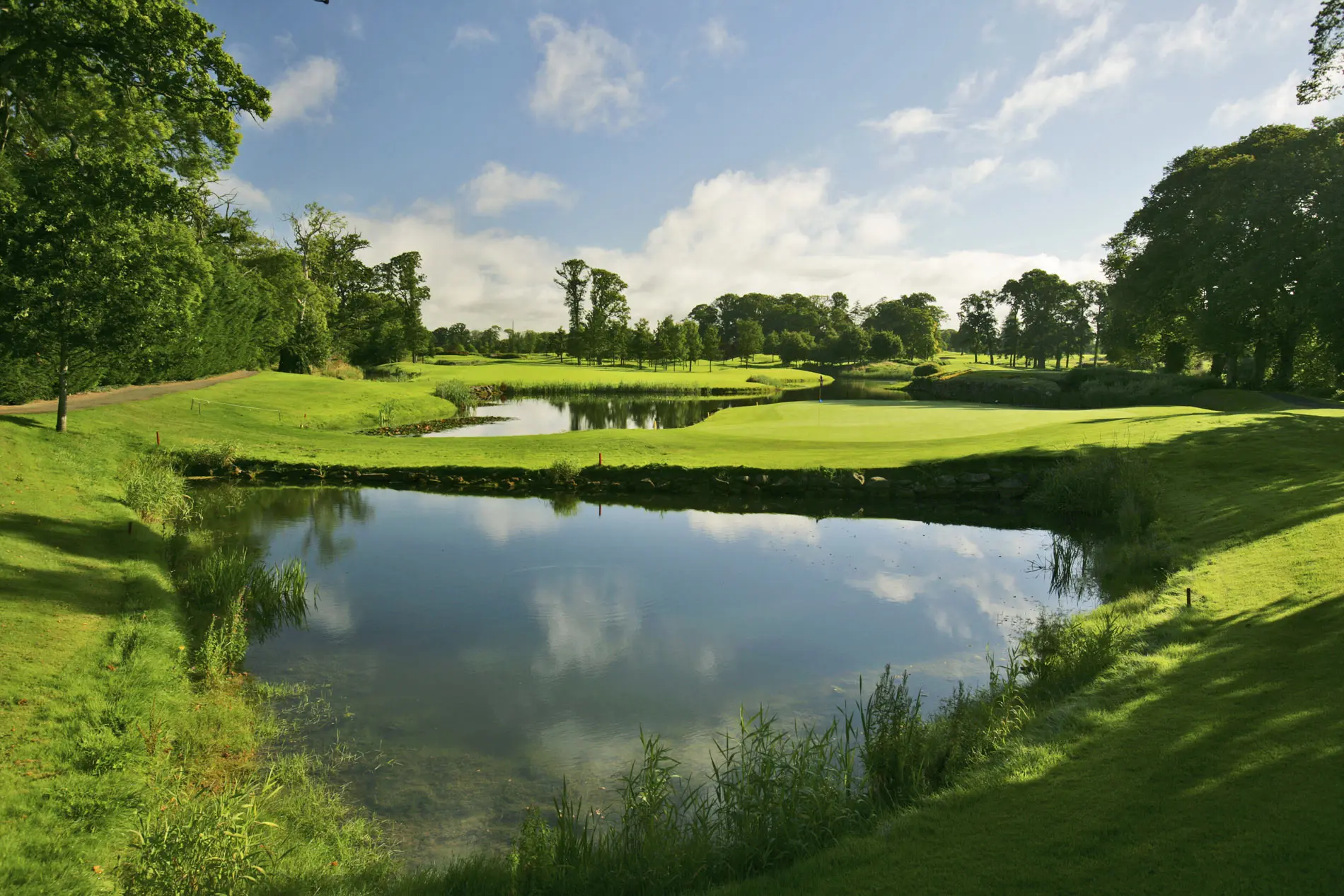 Panoramic view of a well maintained fairway next to a water hazard