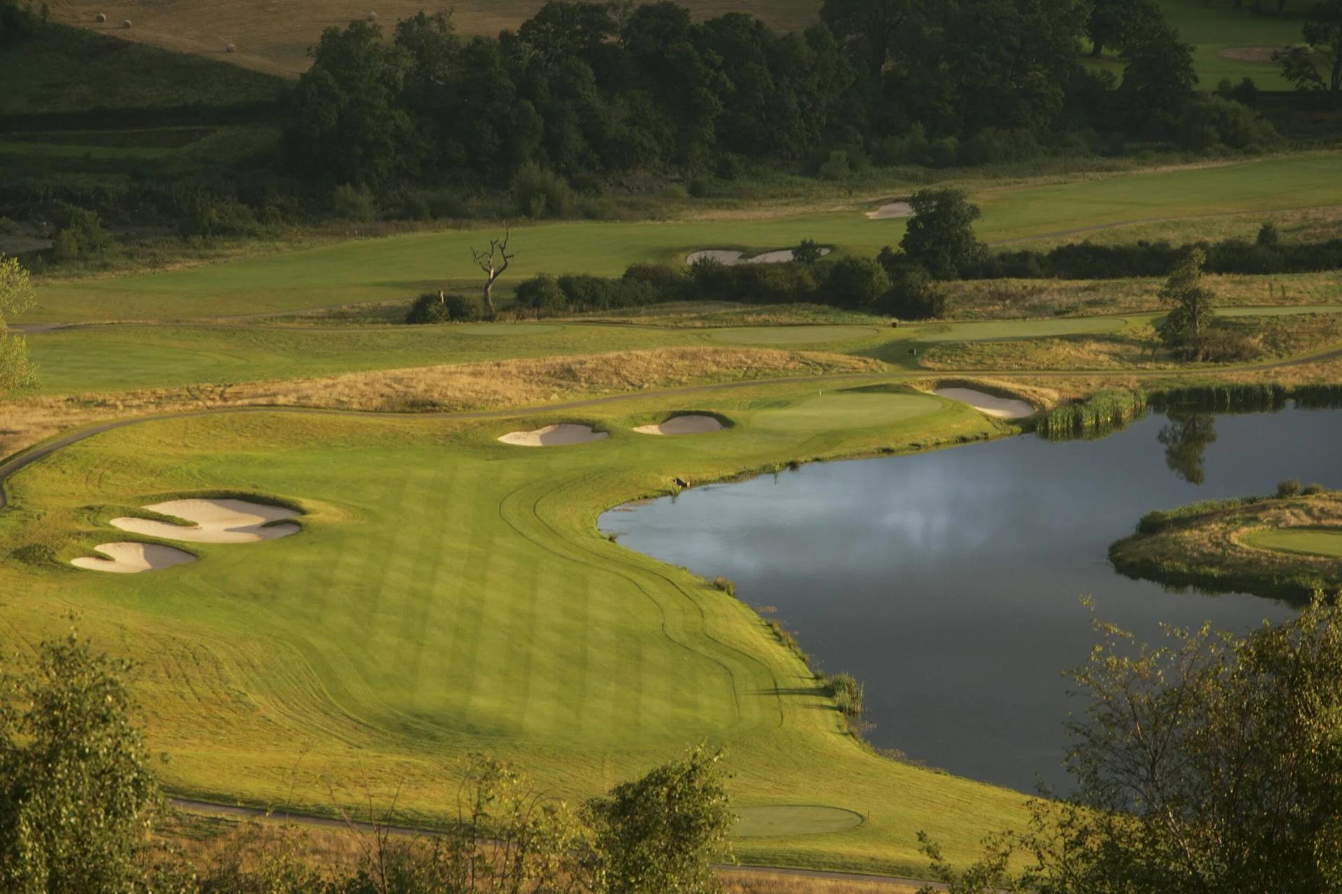 A well maintained fairway nestled with sand bunkers