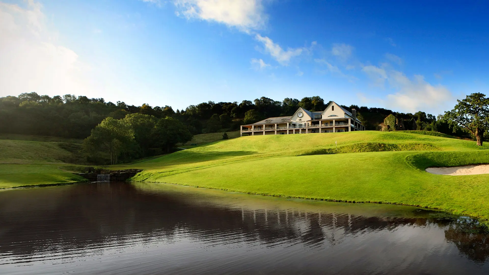 Panoramic view of a well maintained fairway next to a water hazard