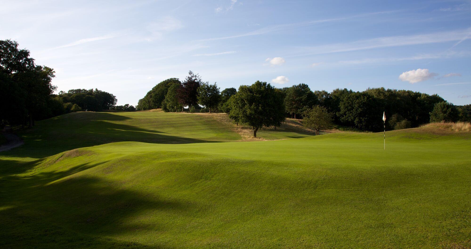 A well maintained fairway under blue skies