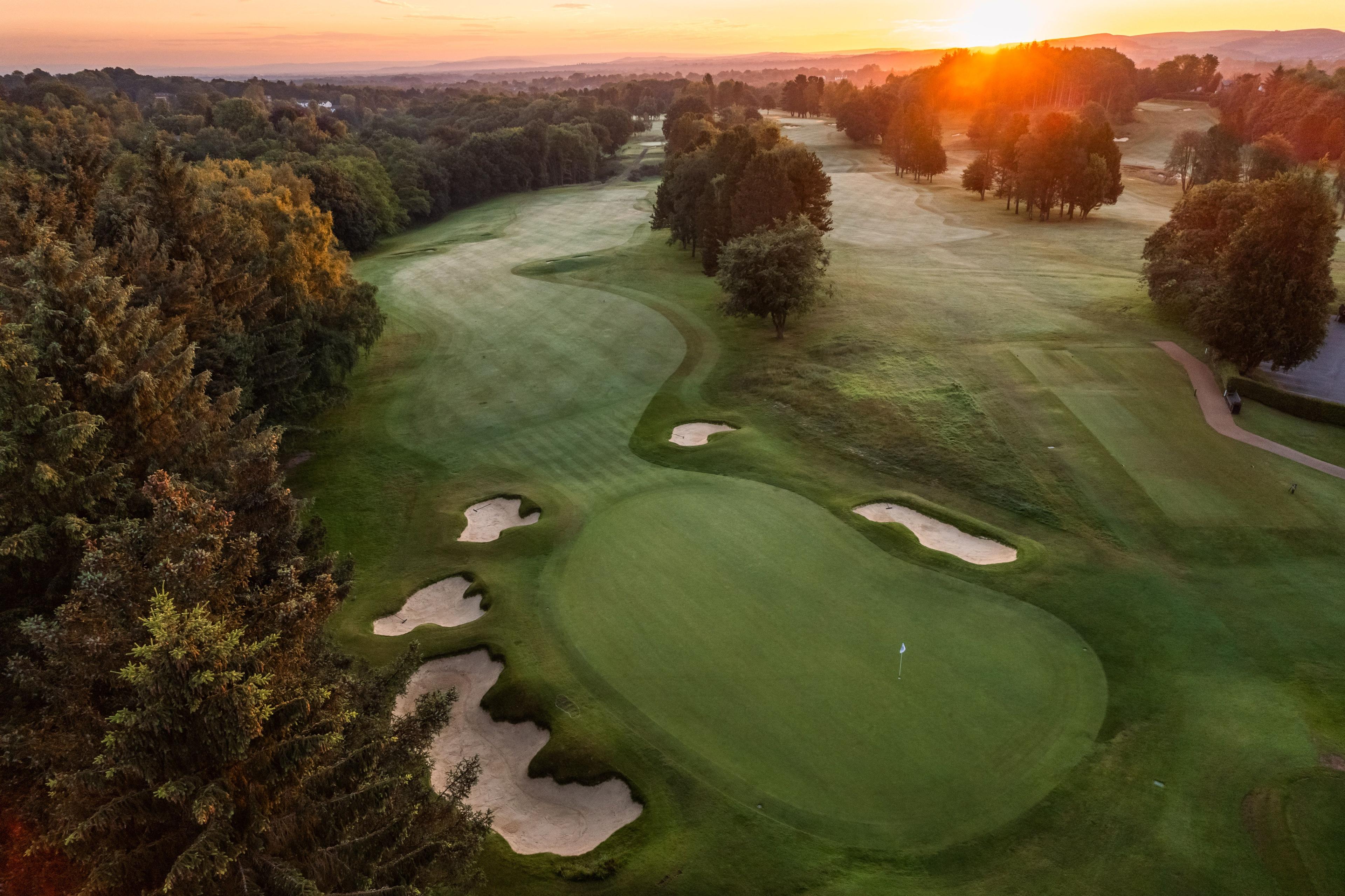 Overhead view of a smooth green surrounded by sand bunkers