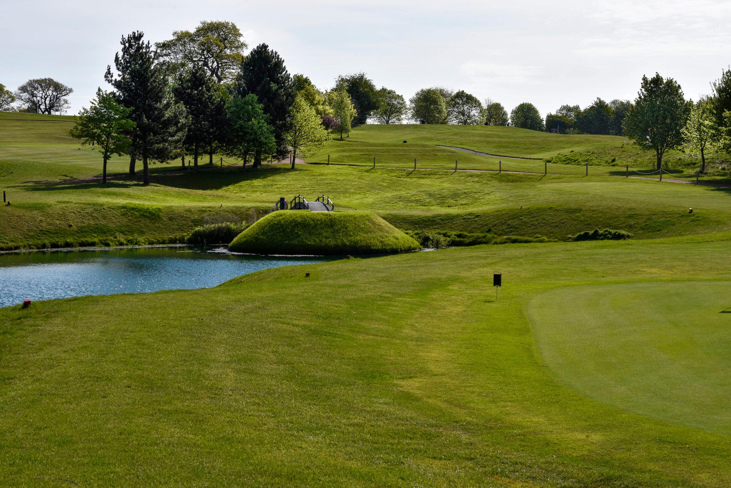 A well maintained fairway and water hazard at The Nottinghamshire Golf & Country Club