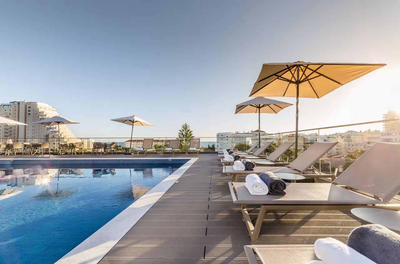 Roof top pool surrounded by sunbeds at The Prime Energize Monte Gordo