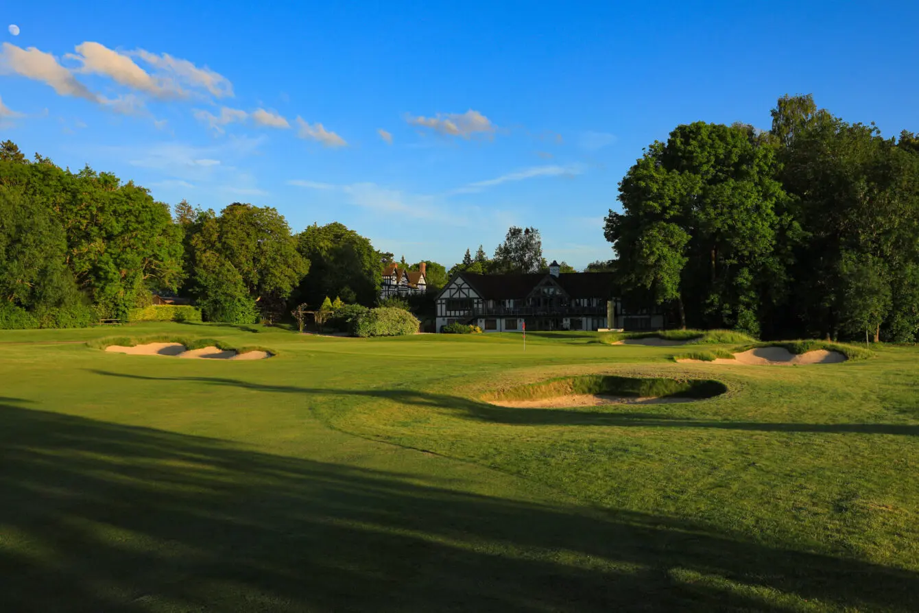 A well maintained fairway nestled with sand bunkers