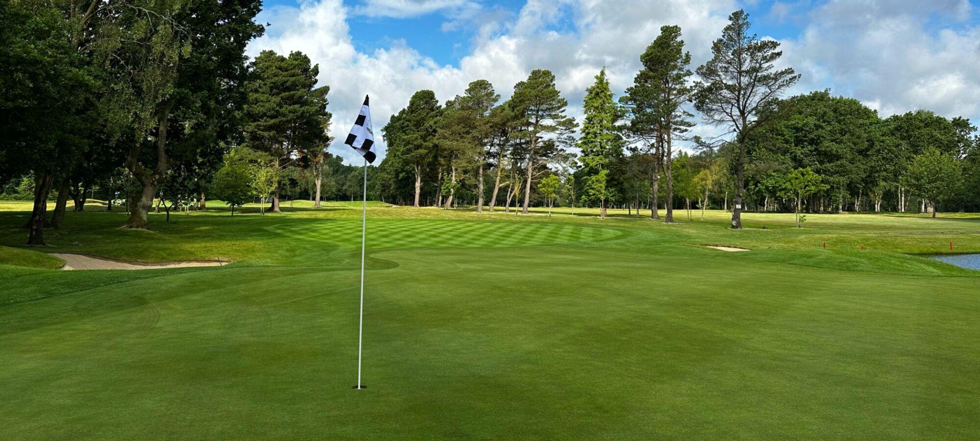 A well maintained fairway leading to a smooth green