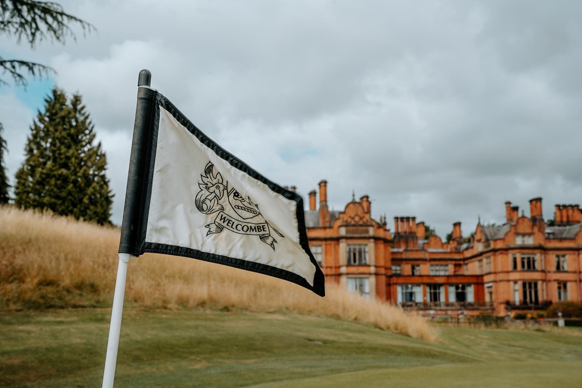 Flagstick with The Welcombe Hotel, BW Premier Collection by Best Western building in the background