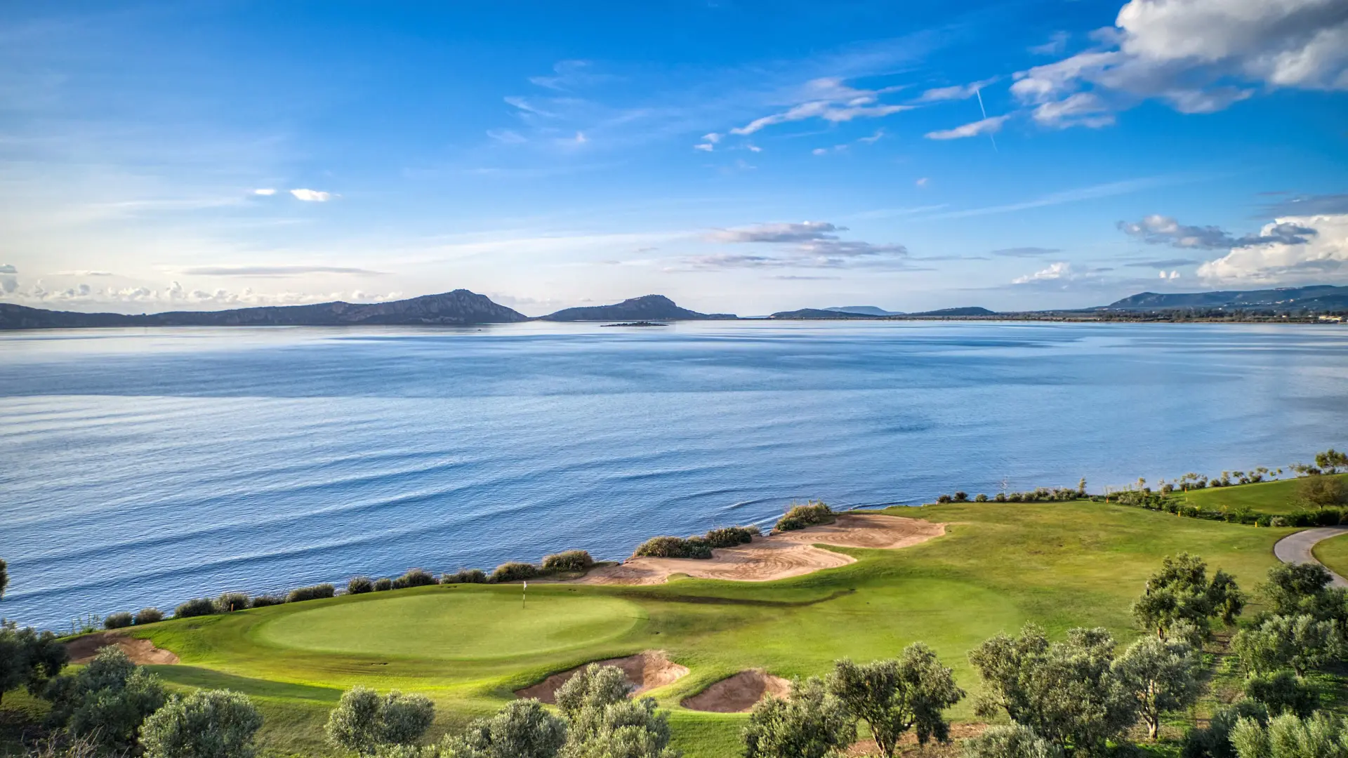 Overhead view of a smooth coastal green with a sand bunker