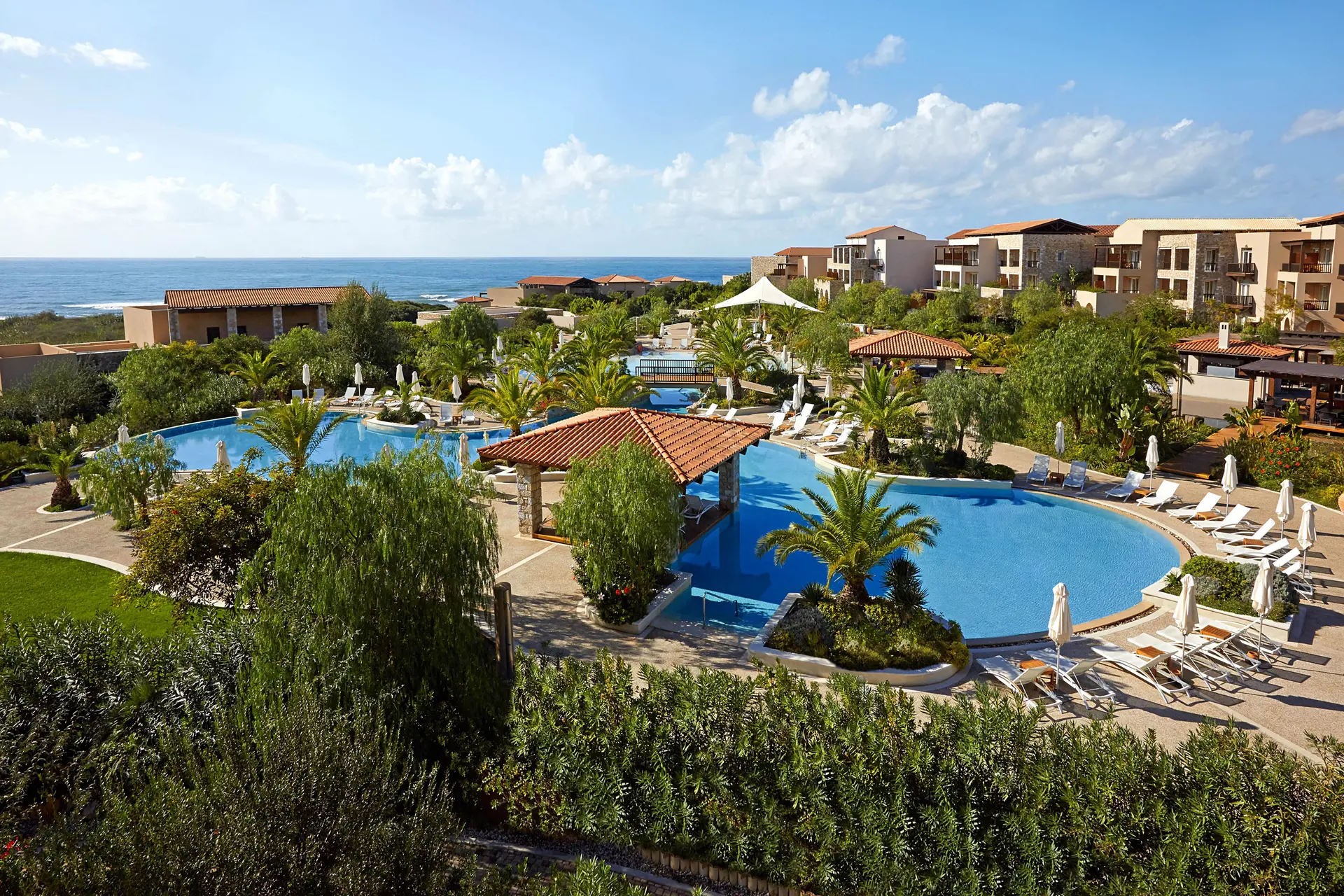Overhead view of the outdoor swimming pool at The Westin Resort Costa Navarino with a water slide