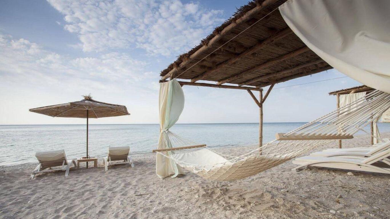 Beach with sunbeds and cabanas at the Thracian Cliffs Golf & Beach Resort