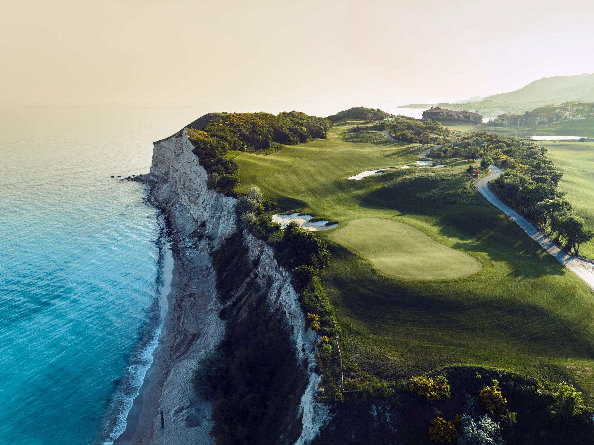 A manicured coastal fairway with sand bunkers