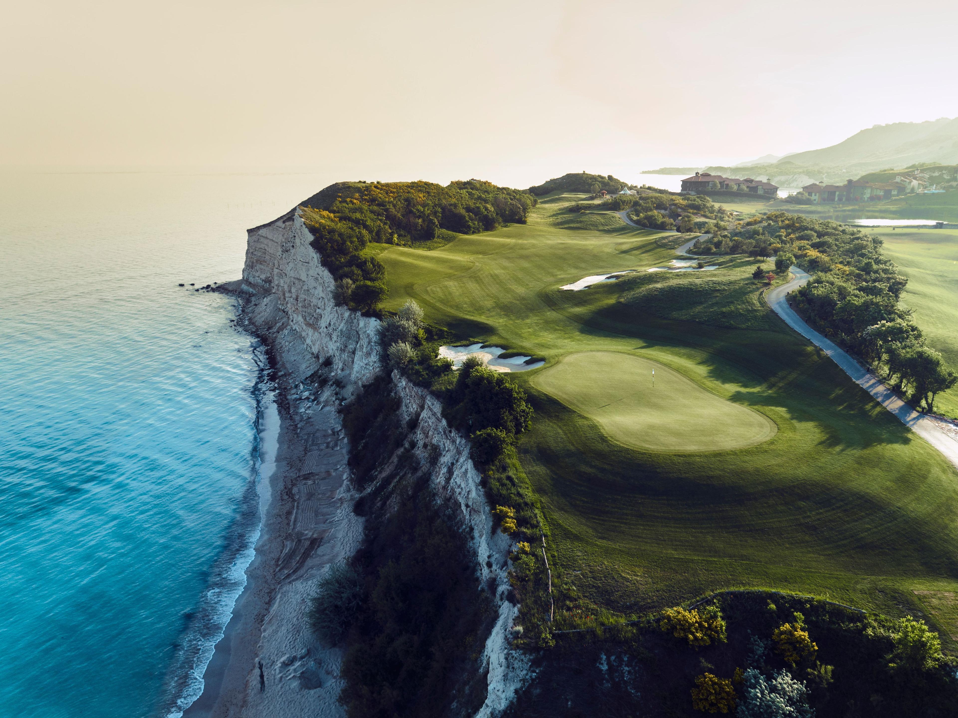 A manicured coastal fairway with sand bunkers