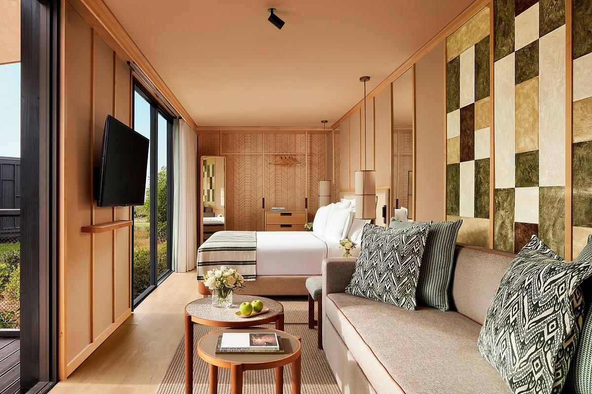 Double bed room with a lounging space and tv as part of a lodge at Tivoli Estela Golf & Lodges Porto