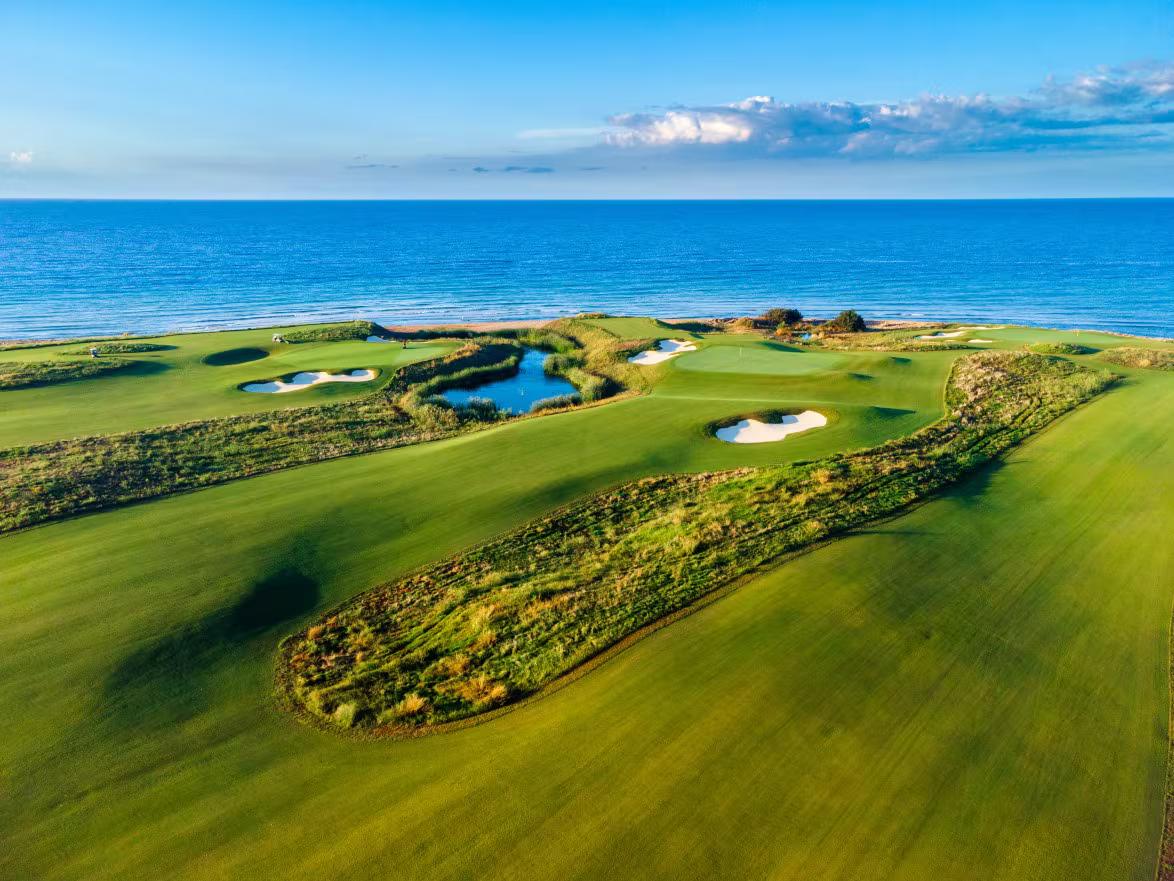 A well maintained fairway with sand bunkers