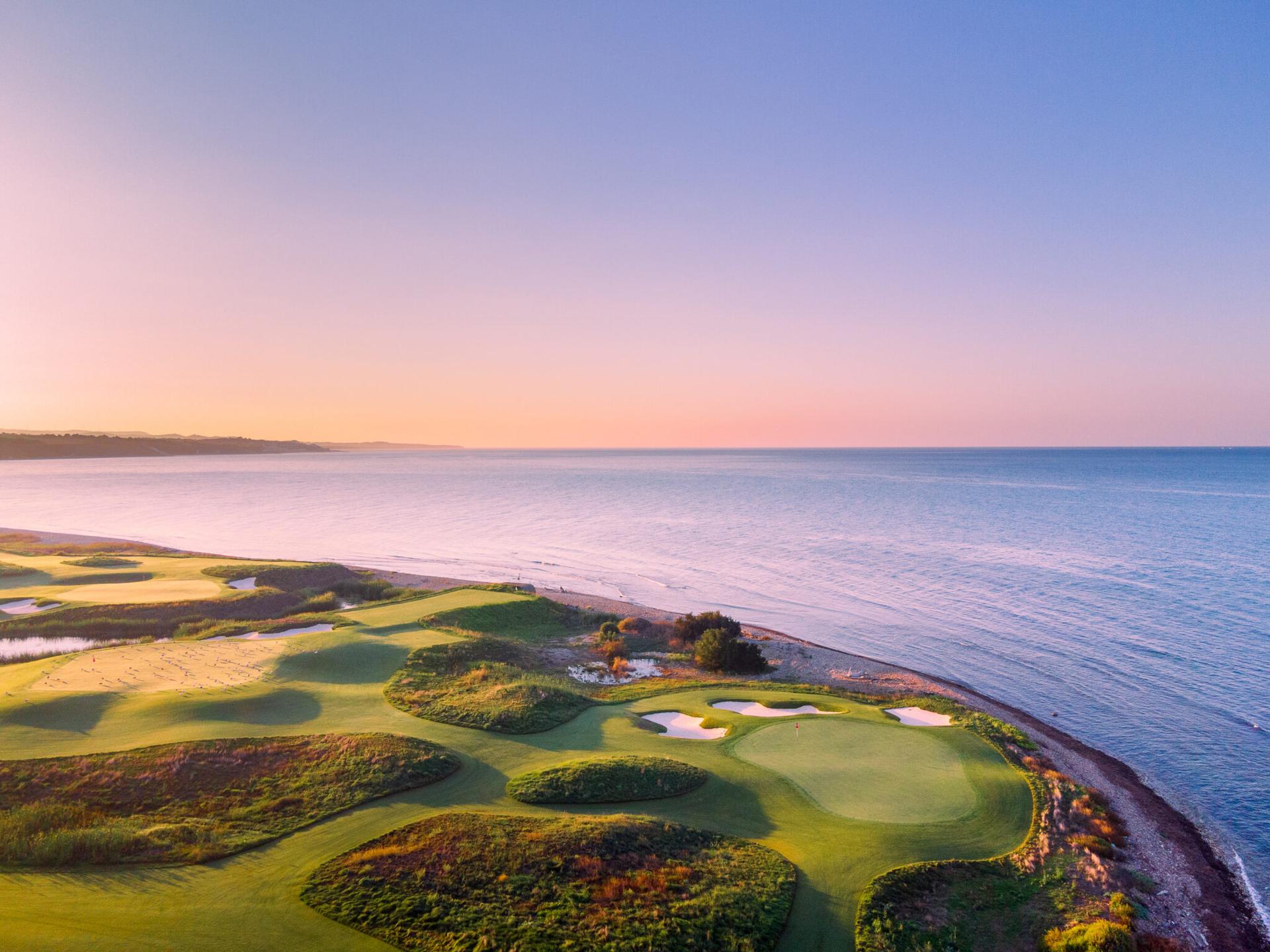 Overhead view of a well maintained coastal green surrounded by sand bunkers