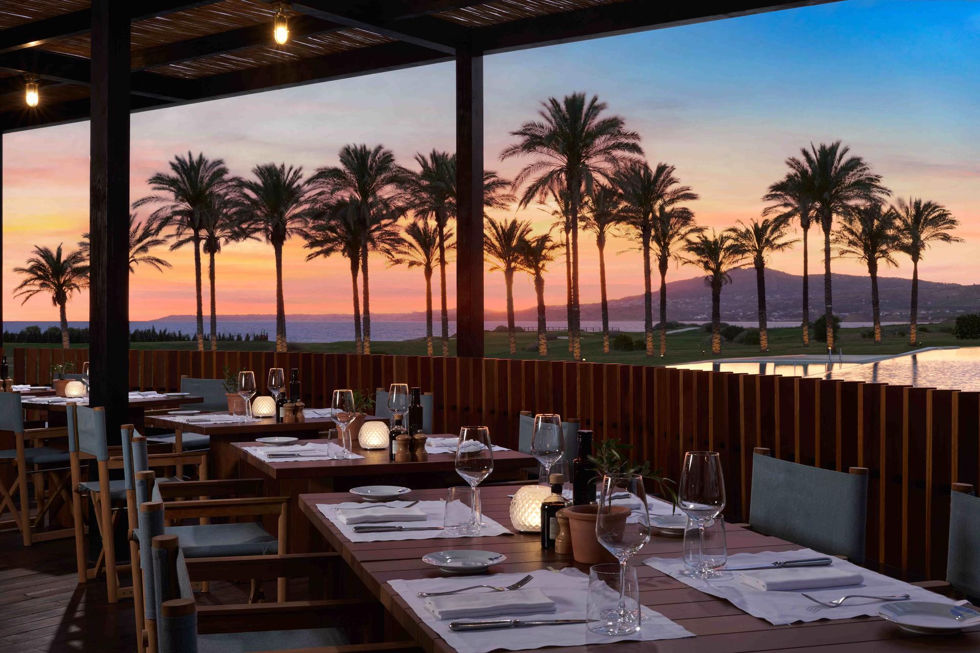 Outdoor dining room at Verdura Resort, Rocco Forte Hotels with the sun setting